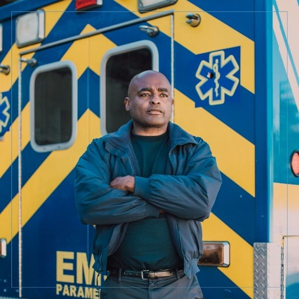 confident man outside EMT ambulance 