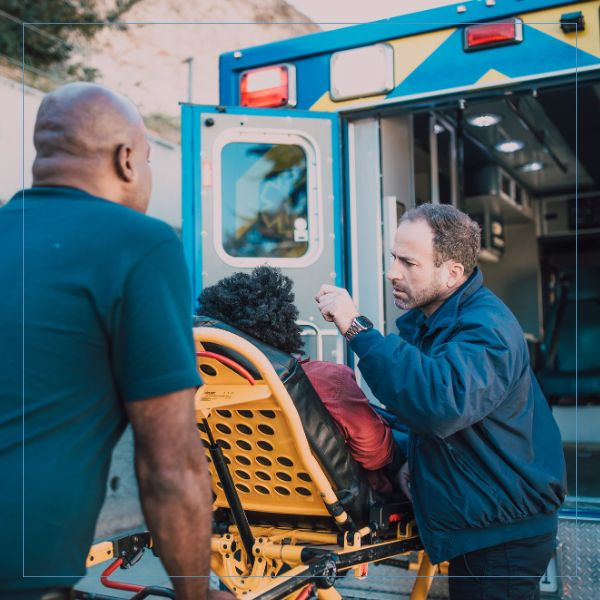 two paramedics attending to a patient Critical Care Paramedic (3).jpg