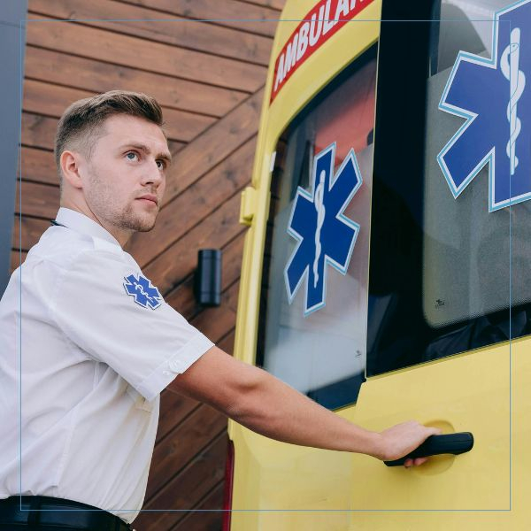 a paramedic opening an ambulance door Paramedic (2).jpg