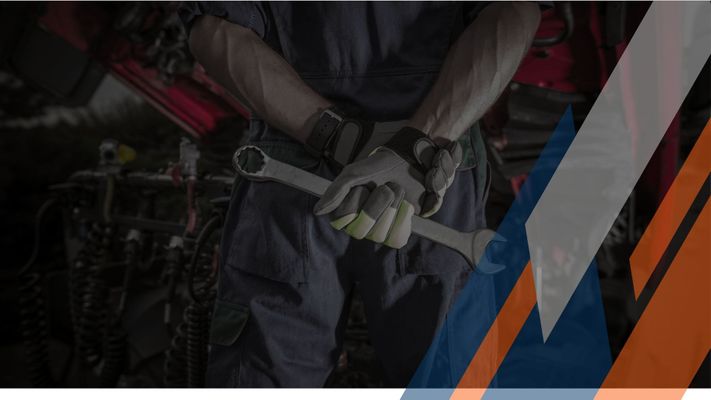 mechanic holding a wrench behind his back. mechanic holding a wrench behind his back.
