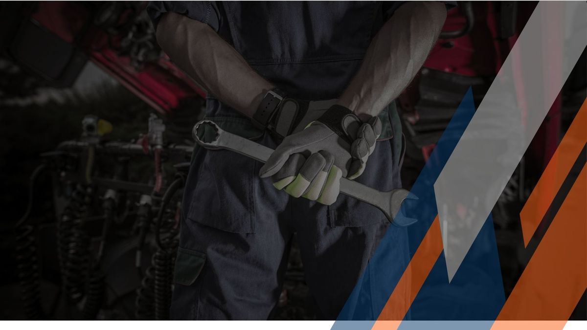 mechanic holding a wrench behind his back. 