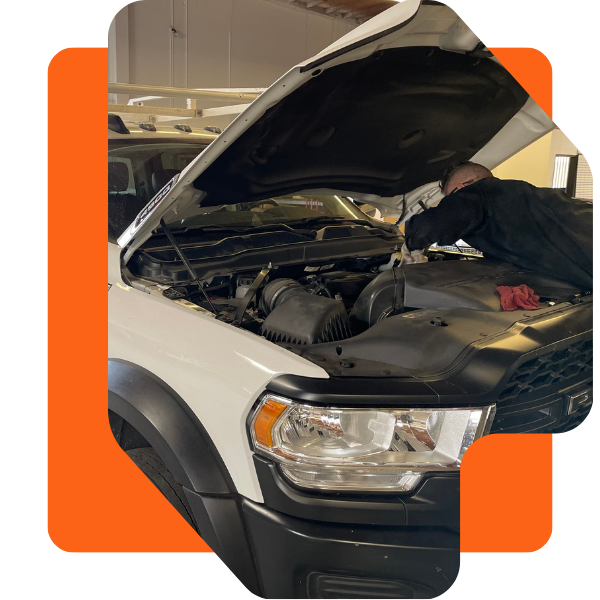 Image of a mechanic inspecting a truck engine