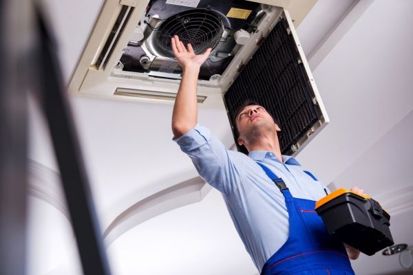 AC contractor repairing AC ventilation system