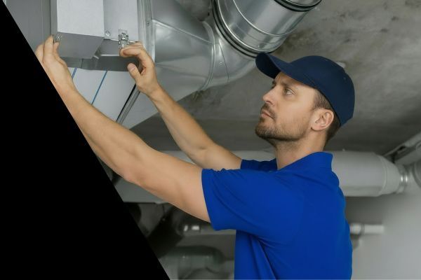 heating contractor checking commercial furnace system ductwork