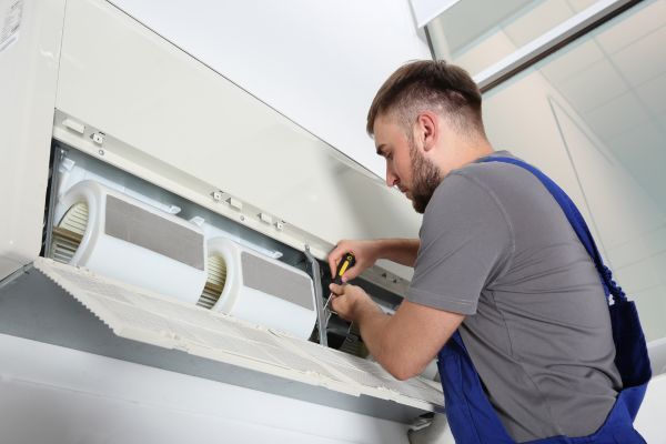 AC technician working on mini split system repairs