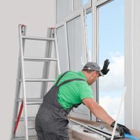 a professional working on windows in a home