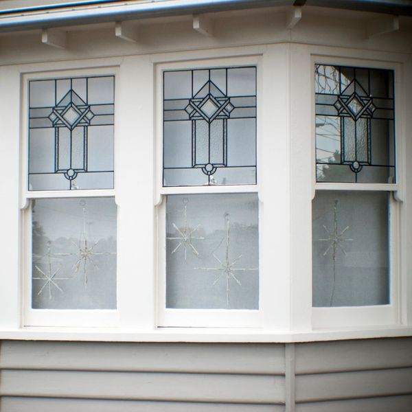 intricate stain glass windows in a bay window