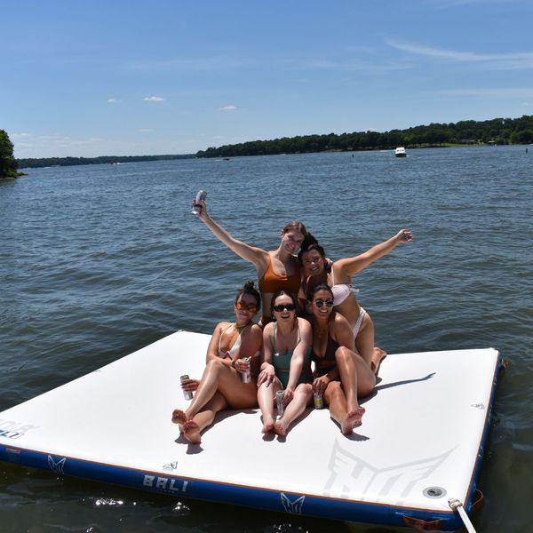 friends on floating mat in water