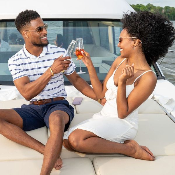 man and woman cheers on yacht