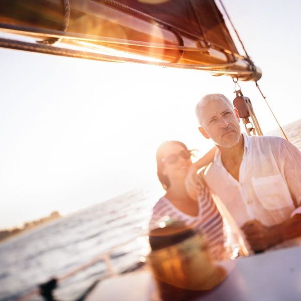A couple enjoying the sunset on a yacht.