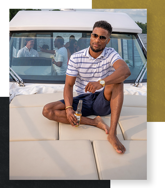 A young man lounging on the sunpad of a yacht