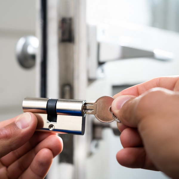 man changing locks on door