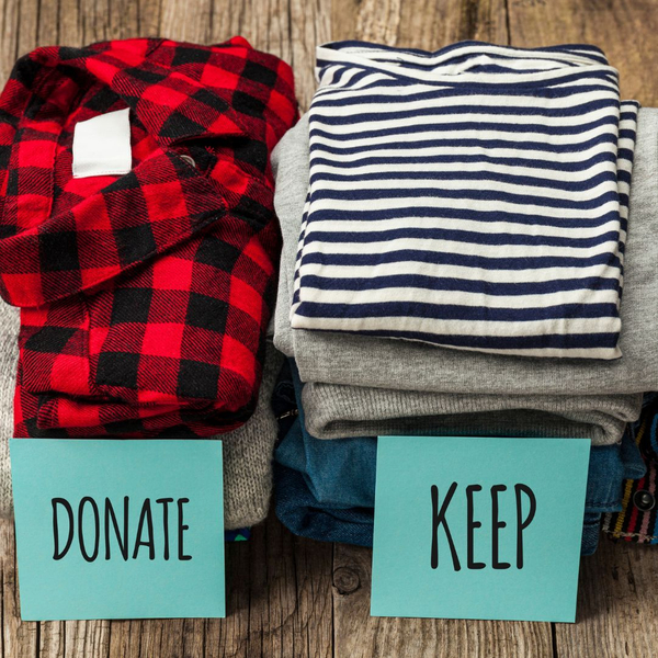 Folded clothes in donate and keep piles