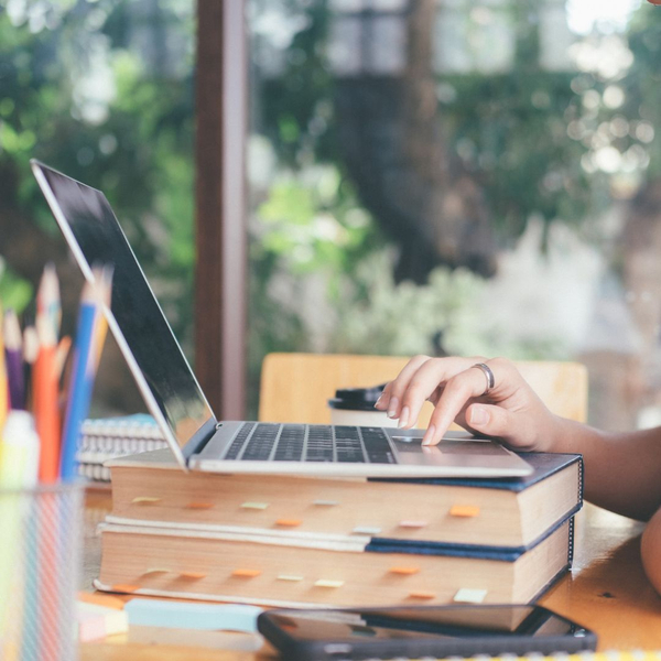 Person on a laptop, on desk Person on a laptop, on desk