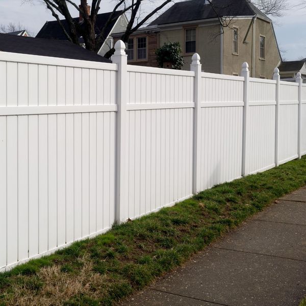 White vinyl fencing along a sidewalk