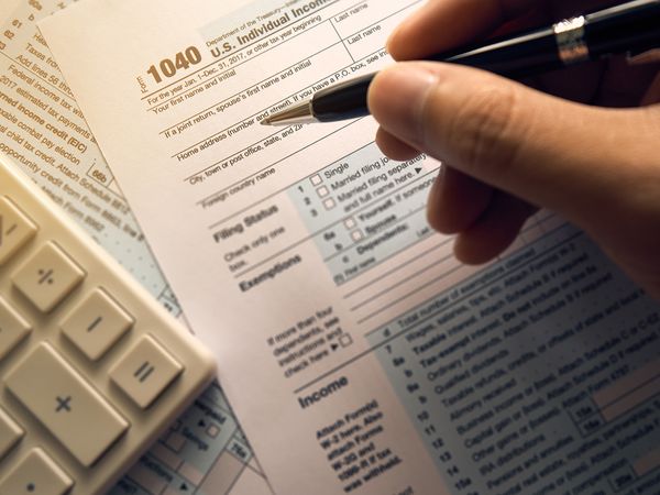 Person filling out a tax form.