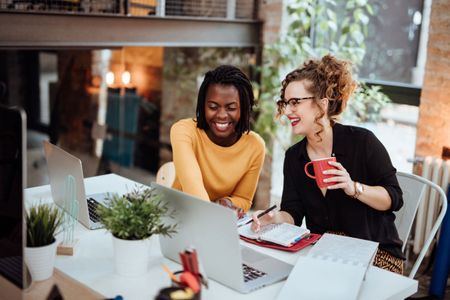 Two women working together