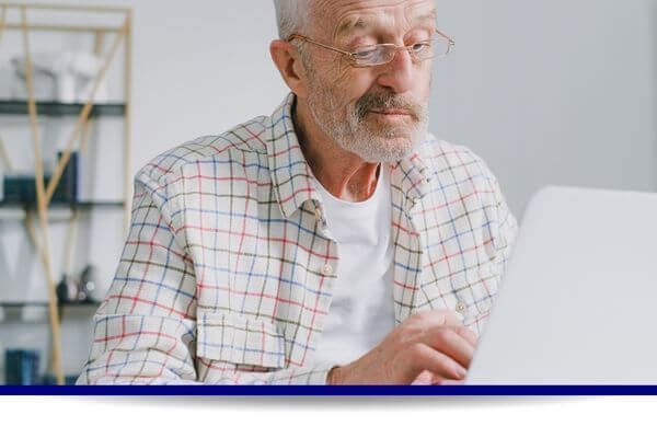 older man on a laptop