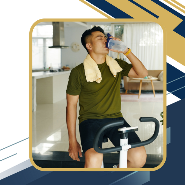 man drinking water on exercise bike 