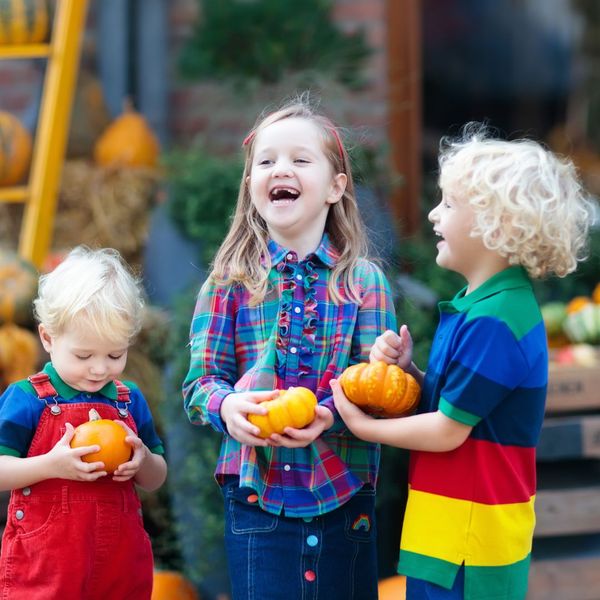 kids laughing at pumpkin patch