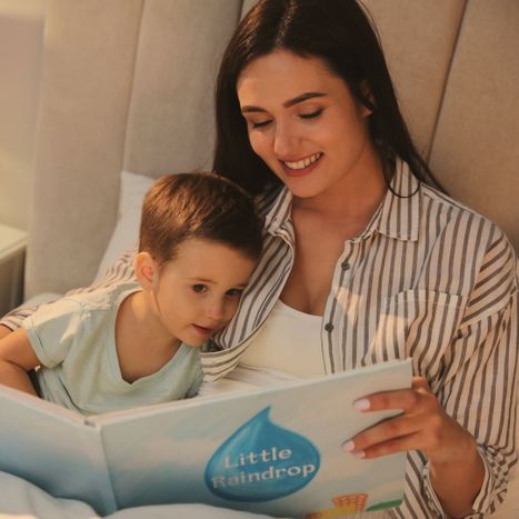 mom reading a story to toddler before bed