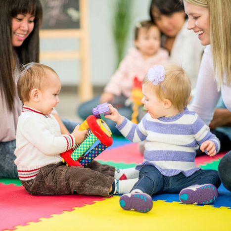 infants playing together while supervised