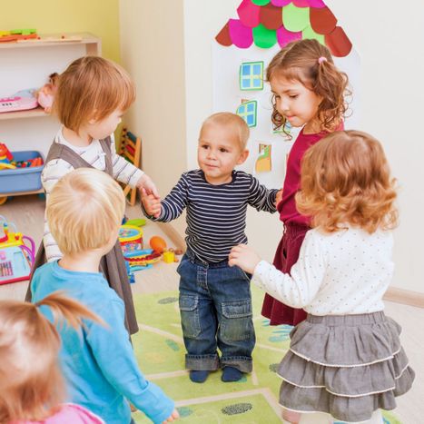 a group of toddlers holding hands together