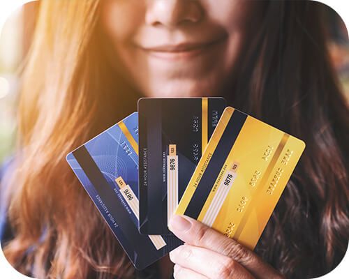woman smiling with credit cards in hand