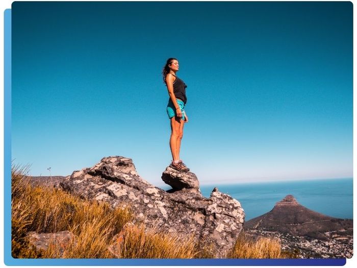 woman breathes in fresh air while standing on rock off hiking trail Katy 2.jpg