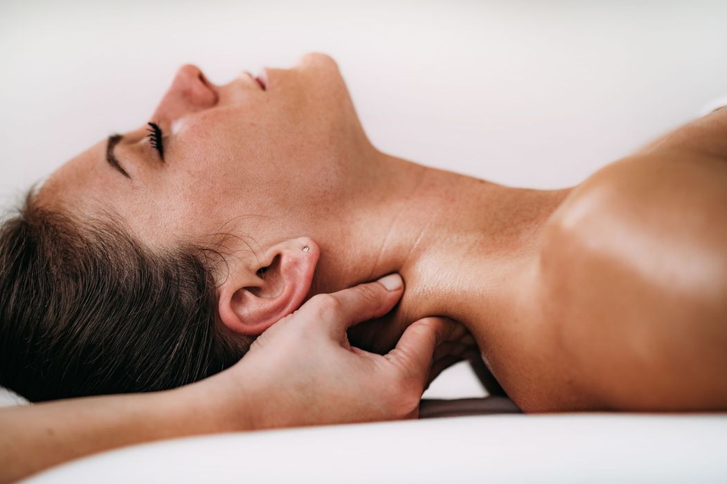 a woman having her neck massaged