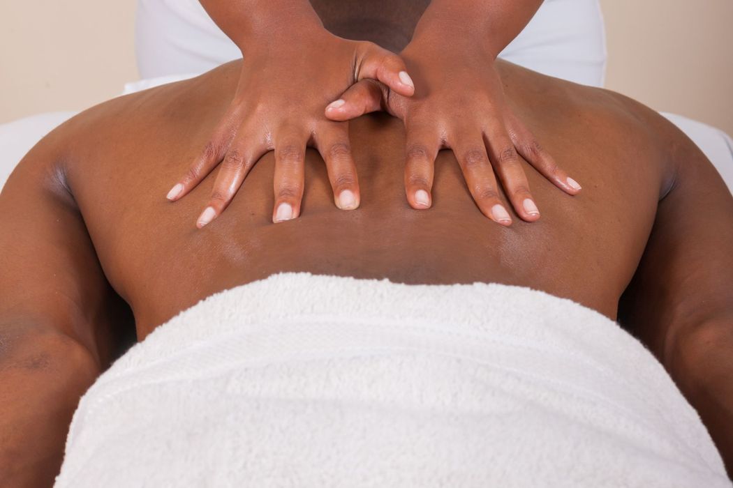 A client relaxing face down on the table during a soothing massage session at our Fort Collins clinic. Relaxing Massage in Fort Collins