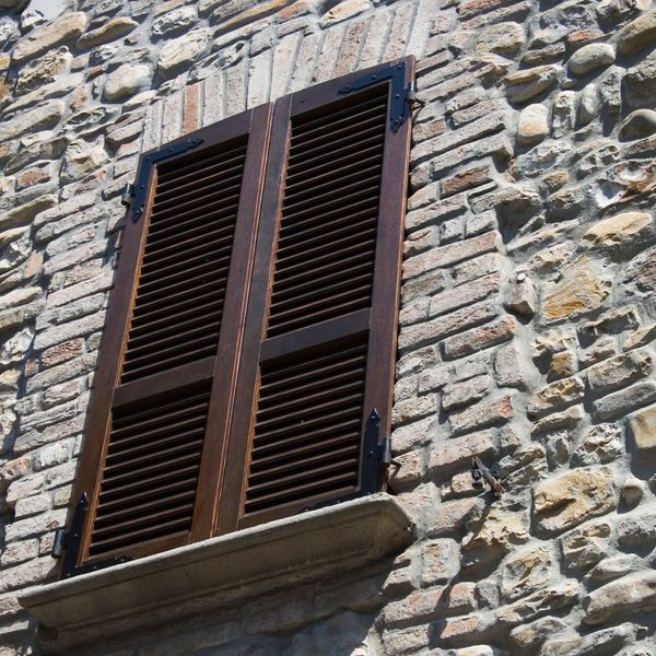 brown plantation shutters covering a window