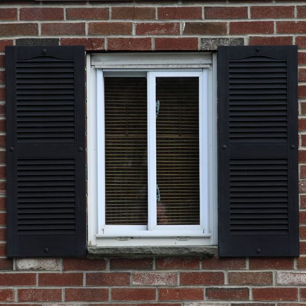 black plantation shutters on a white window