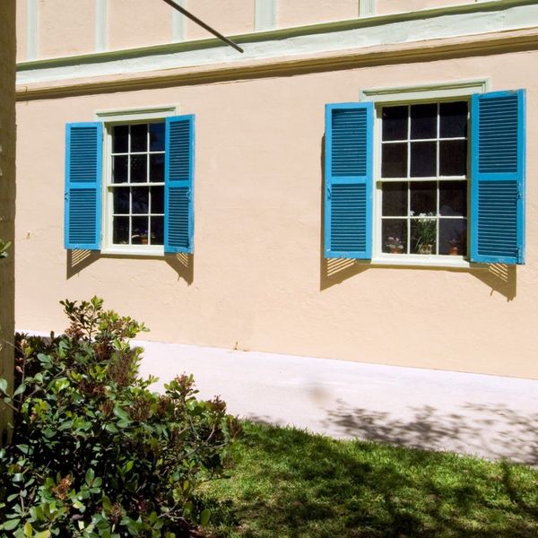 sky blue plantation shutters on a homes windows