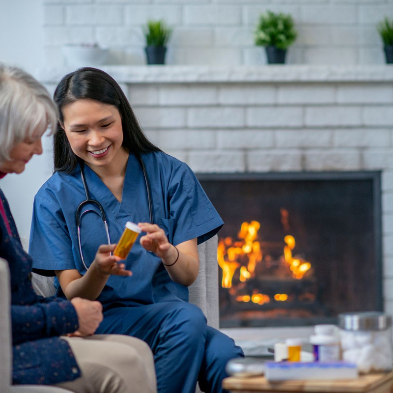 A caregiver discusses medications with a senior