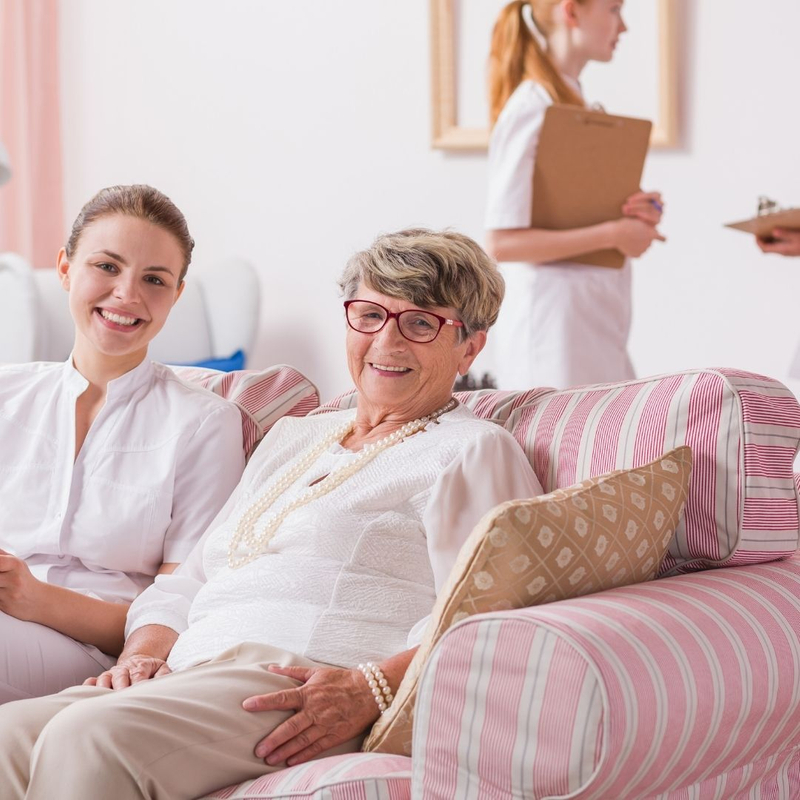 young woman with elderly woman in assisted living facility