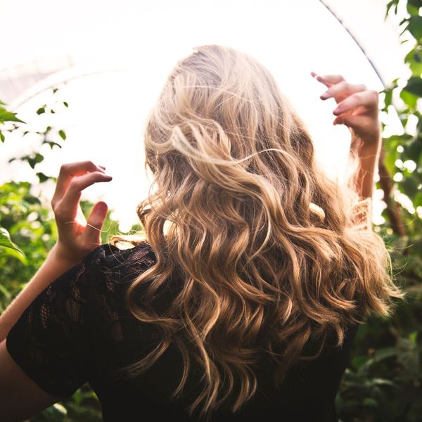 womans curly blonde hair