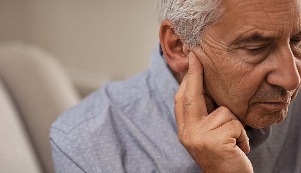 A man experiencing hearing loss.