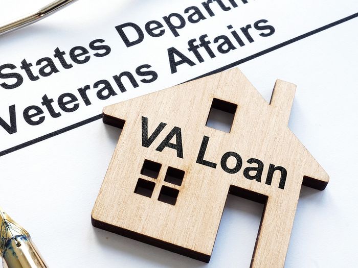 Image of a wooden house with the words VA loan inscribed on the front