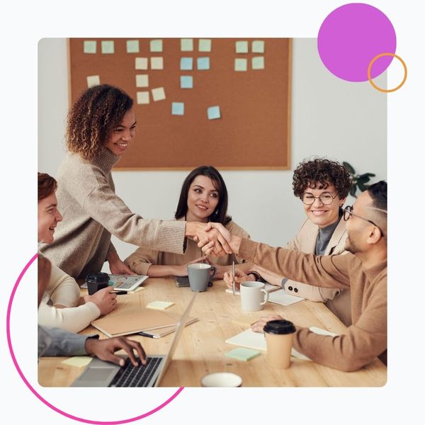 handshake across meeting table