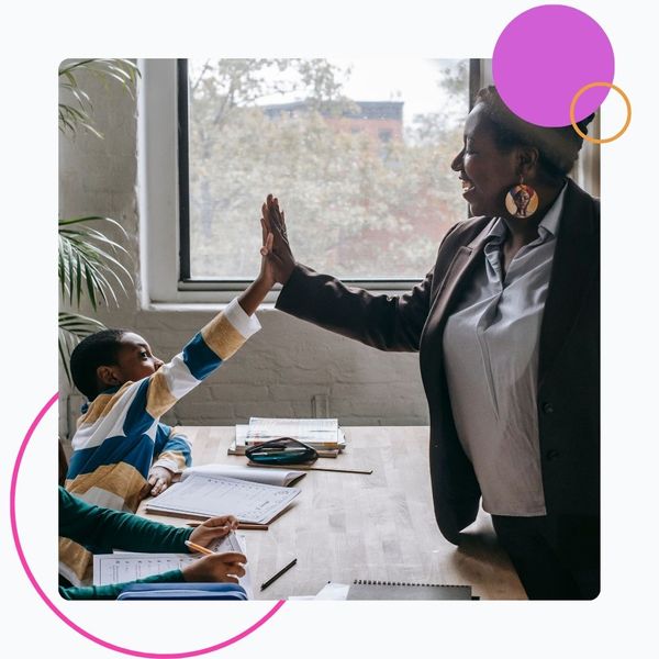 teacher giving student high-five