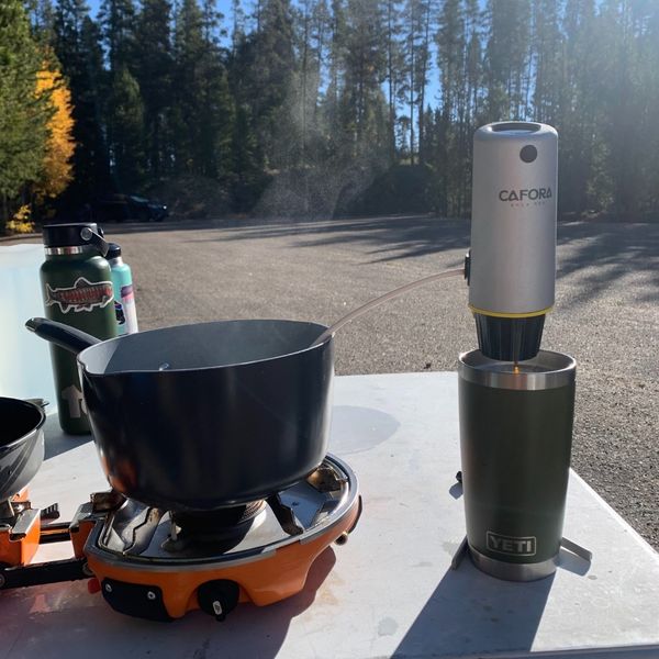 CAFORA brewing next to a stove pot