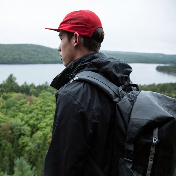 man in red hat wearing backpack on trail CAFORA Partnership with Jo Coffee 1.jpg