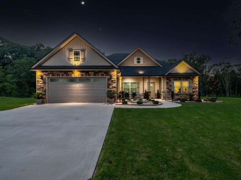 a newly built house with newly installed landscaping at night