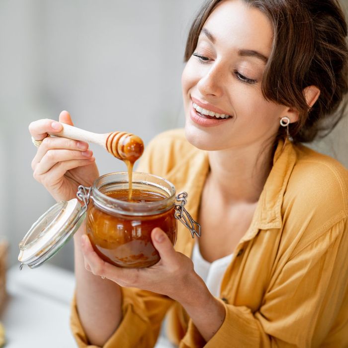 Woman eating raw honey