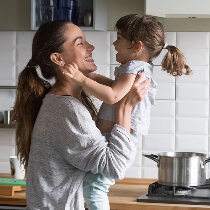 joyful mother and child in kitchen