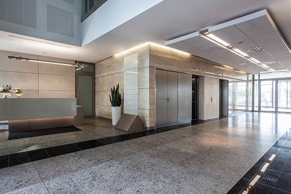 Office lobby with tile floors in front of elevator bay