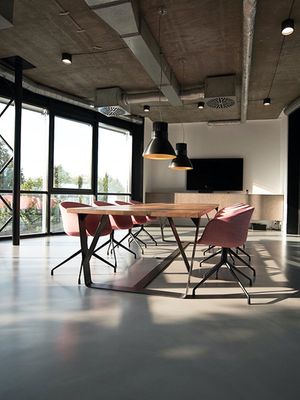 Modern office with cement floors and meeting table