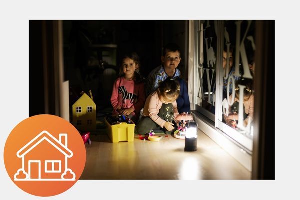 kids playing together in the dark with a lantern on