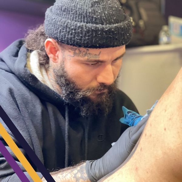 tattoo artist tattooing a client